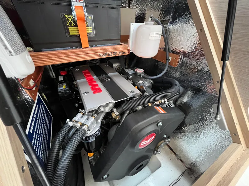 Slide: The Image of Engine compartment of a 2021 Hanse 418 yacht, featuring a Yanmar engine. - 21