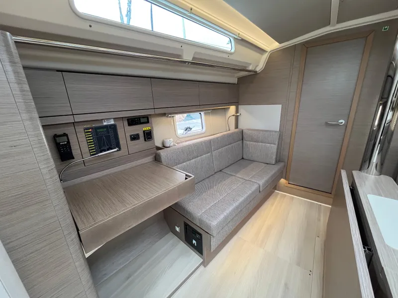 Slide: The Image of 2021 Hanse 418 yacht interior with modern seating and navigation equipment. - 30