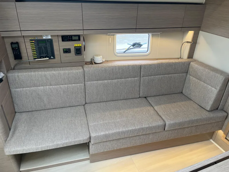 Slide: The Image of 2021 Hanse 418 yacht interior with modern gray sofa and control panel. - 38