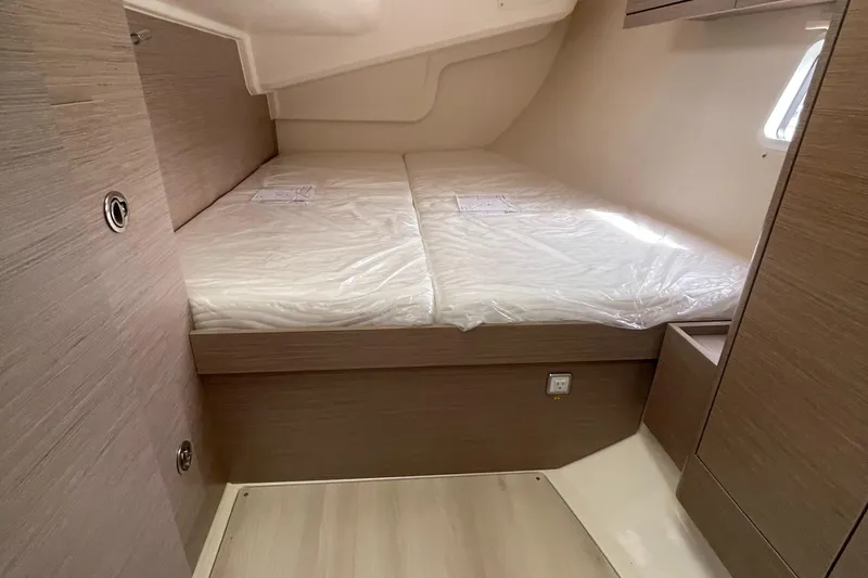 Slide: The Image of 2021 Hanse 418 yacht cabin with twin beds, modern wood finish, and natural light. - 24