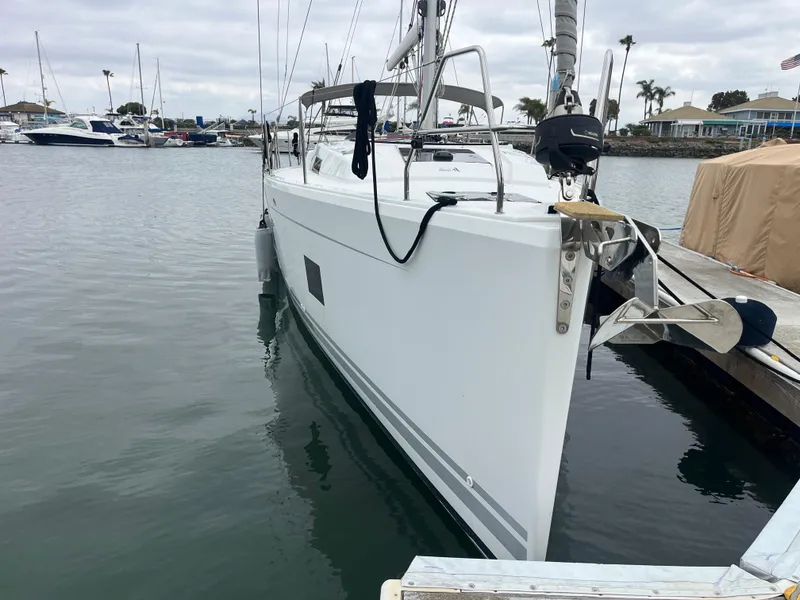 Slide: The Image of 2021 Hanse 418 sailboat docked in a marina, overcast sky, calm water. - 5