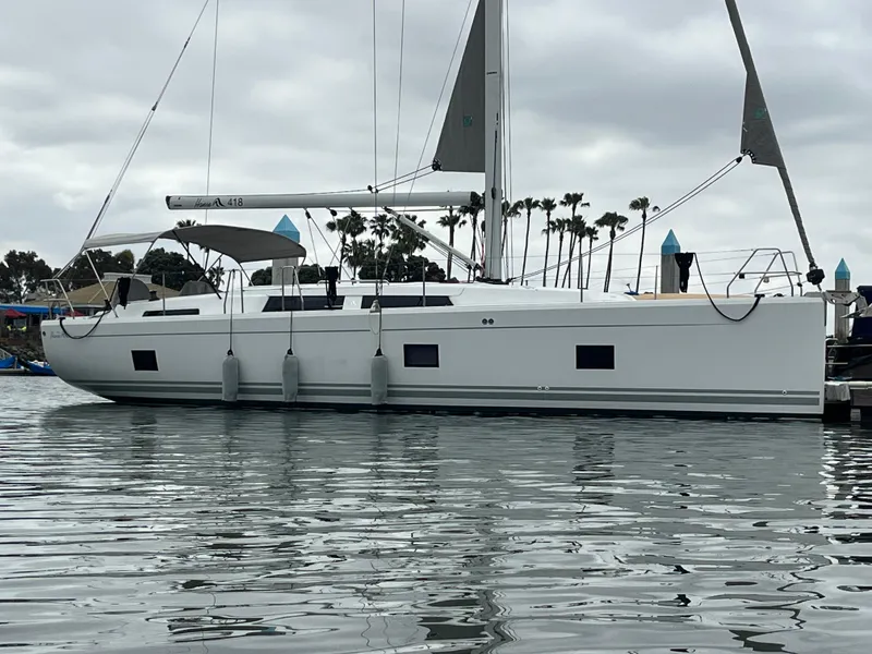 Slide: The Image of 2021 Hanse 418 yacht docked in a marina with overcast skies. - 7