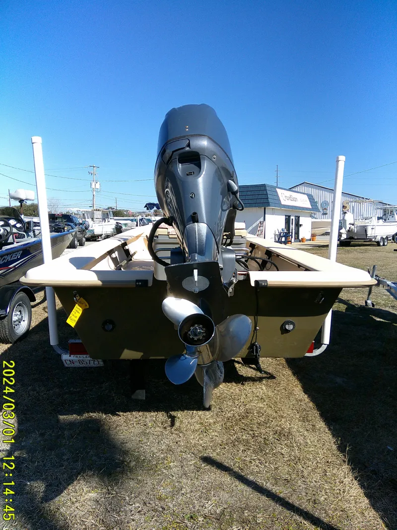 Slide: The Image of 2017 Jones Brothers 17 BATEAU boat with outboard motor, displayed outdoors. - 11