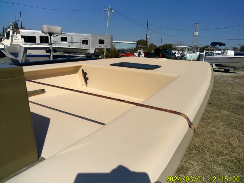 Slide: The Image of 2017 Jones Brothers 17 BATEAU boat, beige deck, parked outdoors, clear sky. - 13