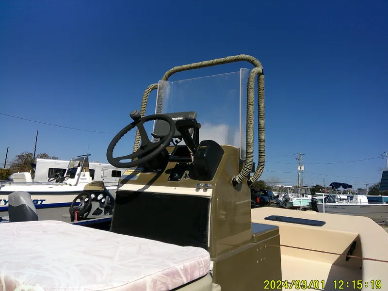 Slide: The Image of 2017 Jones Brothers 17 BATEAU boat console with steering wheel under clear blue sky. - 16