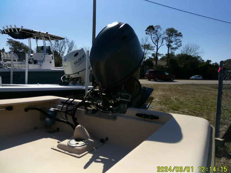 Slide: The Image of 2017 Jones Brothers 17 BATEAU boat with outboard motor in a sunny outdoor setting. - 7