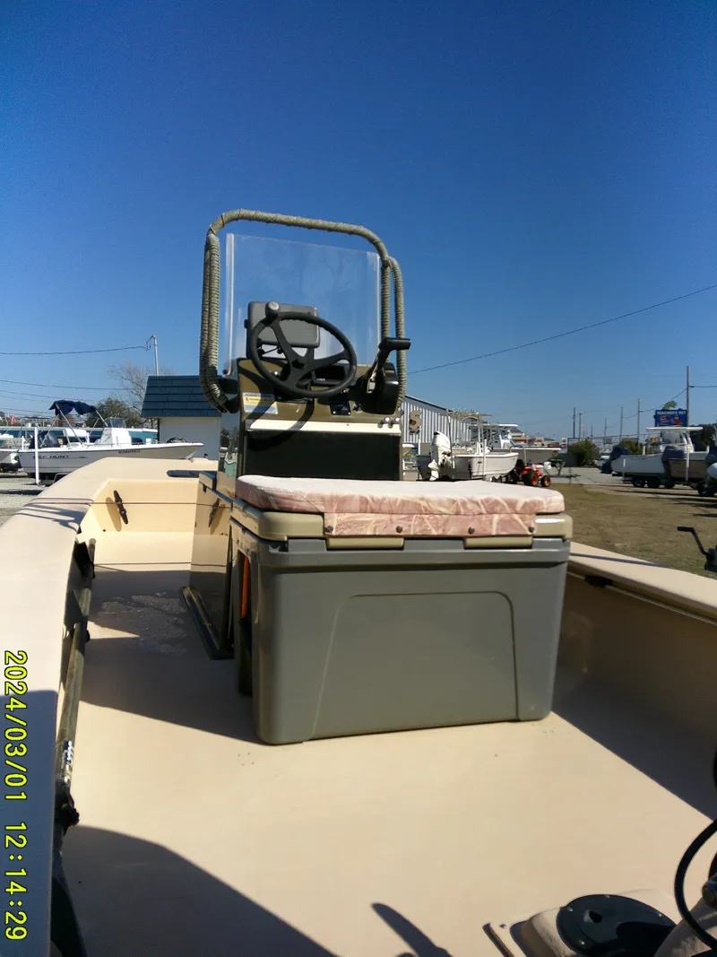 Slide: The Image of 2017 Jones Brothers 17 BATEAU boat with center console and seating, docked outdoors. - 9