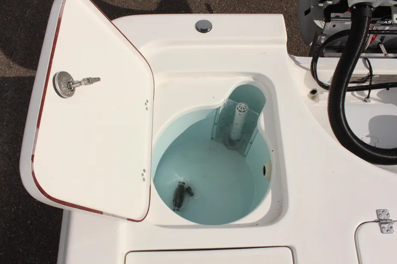 Slide: The Image of Livewell compartment on a 2025 Sea Pro 230 Bay boat, open lid showing water inside. - 15