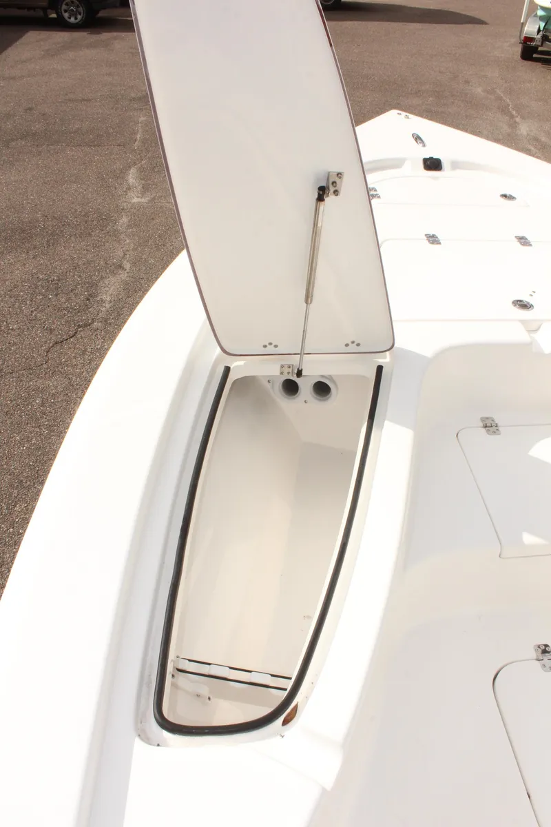 Slide: The Image of 2025 Sea Pro 230 Bay boat storage compartment open on deck. - 24