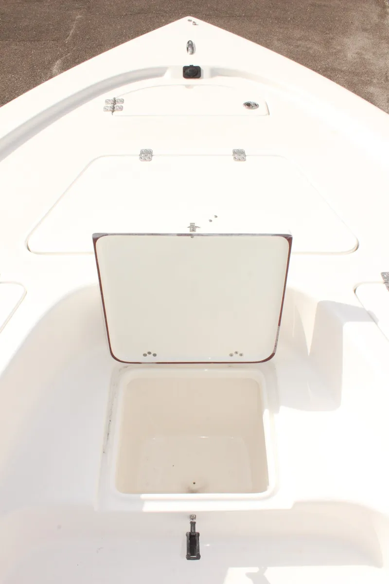 Slide: The Image of 2025 Sea Pro 230 Bay boat deck with open storage compartment. - 25