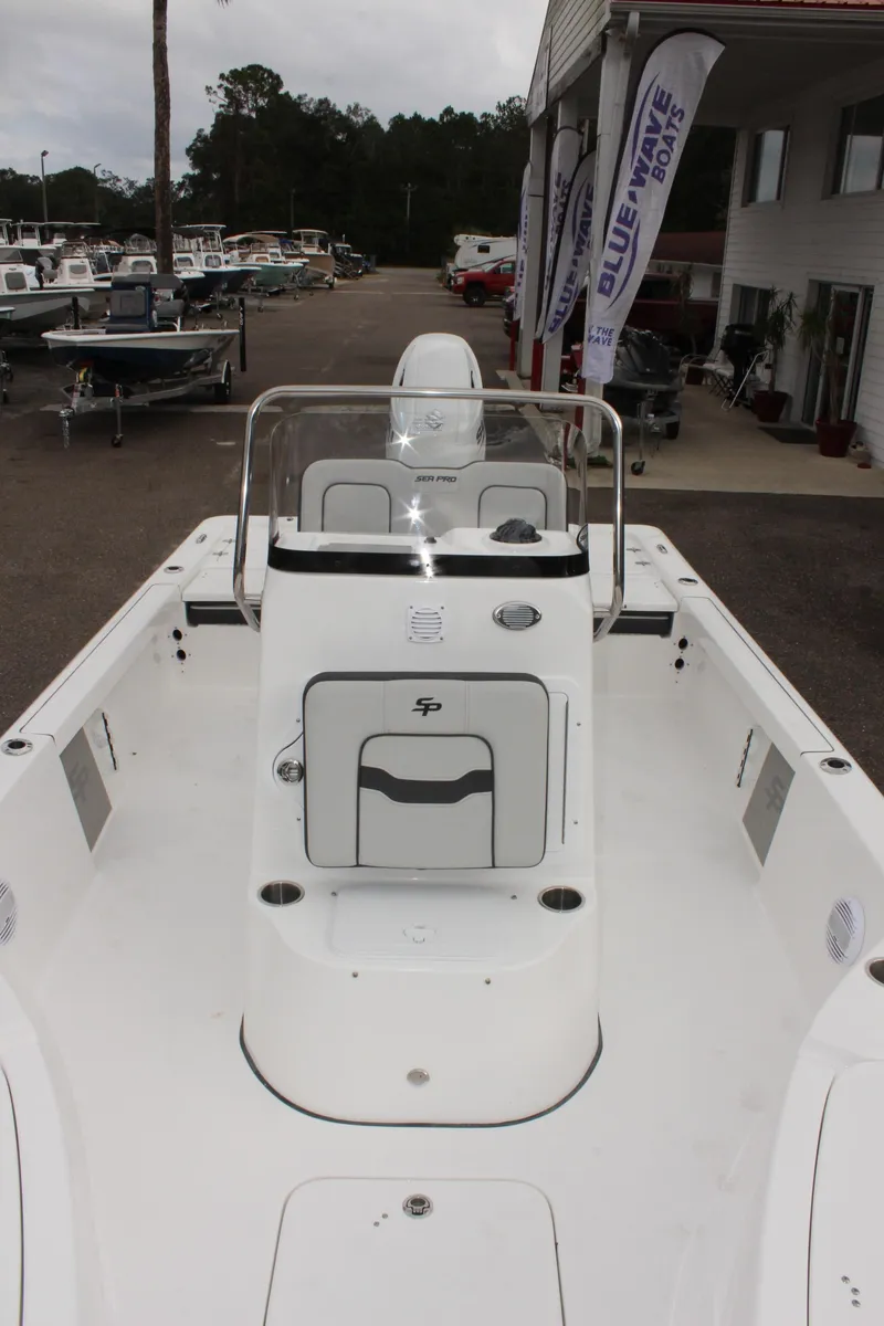 Slide: The Image of 2025 Sea Pro 230 Bay boat, white deck, parked at a marina. - 30