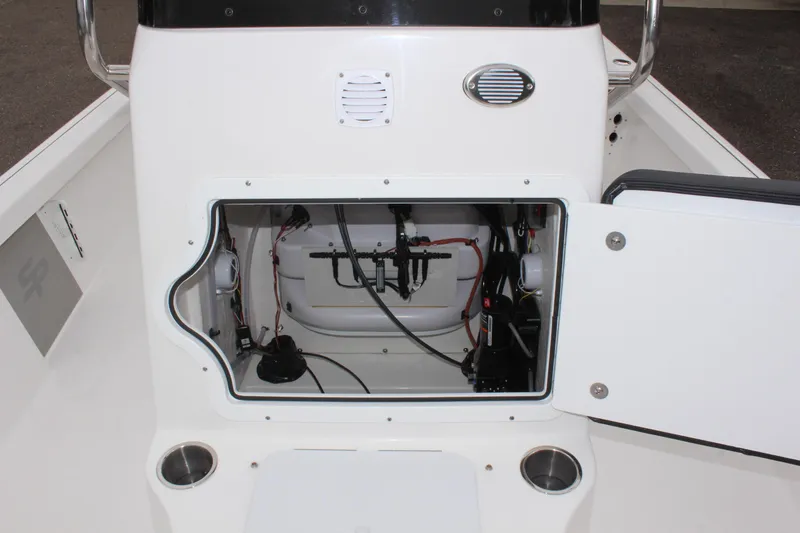 Slide: The Image of 2025 Sea Pro 230 Bay boat console with open storage compartment, showcasing internal wiring and components. - 34