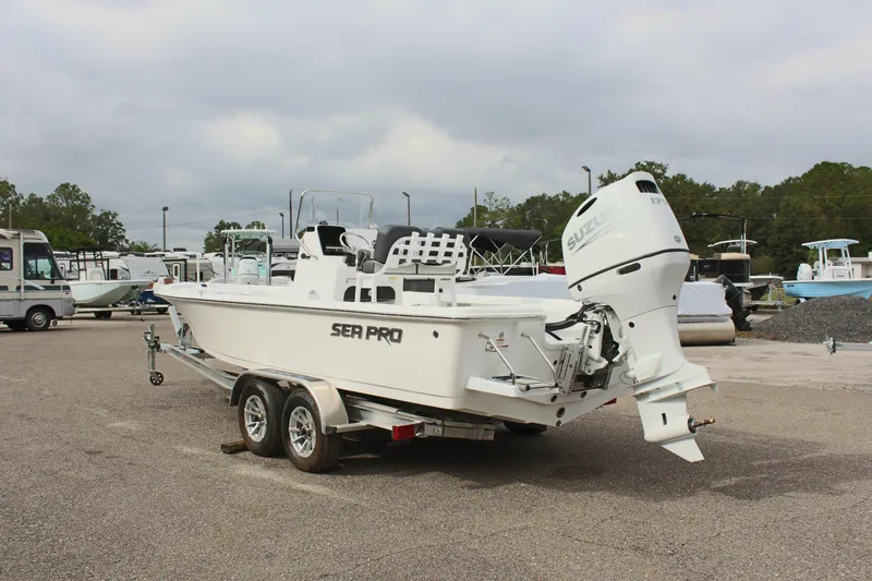 Slide: The Image of 2025 Sea Pro 230 Bay boat on trailer in a marina parking lot. - 38