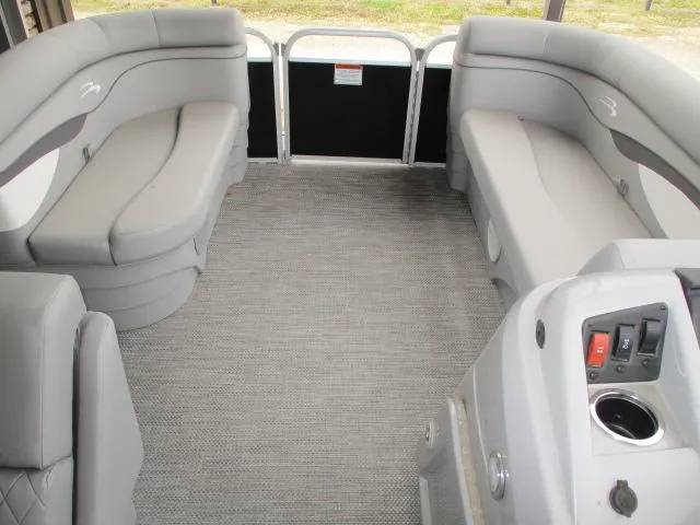 Slide: The Image of 2024 Bennington 188SV pontoon boat interior with gray seating and control panel. - 3