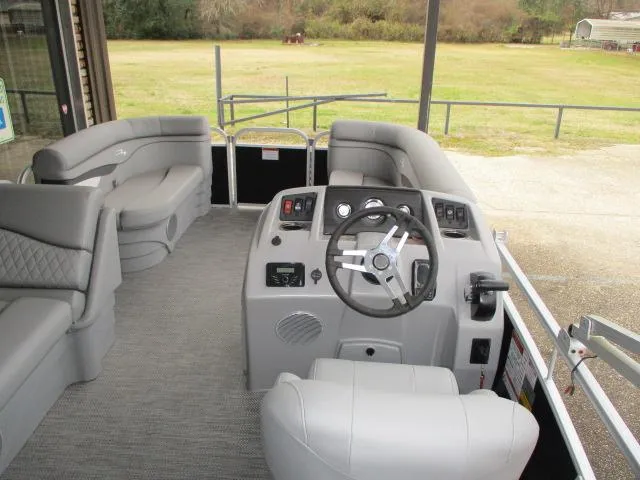 Slide: The Image of 2024 Bennington 188SV pontoon boat interior with gray seating and steering console. - 5
