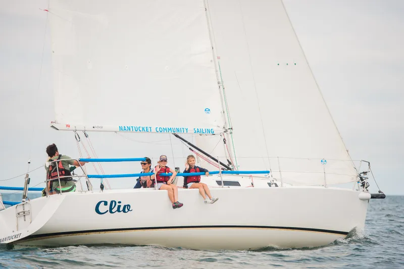Slide: The Image of 2001 J Boats J/105 sailboat "Clio" with crew sailing on open water. - 0