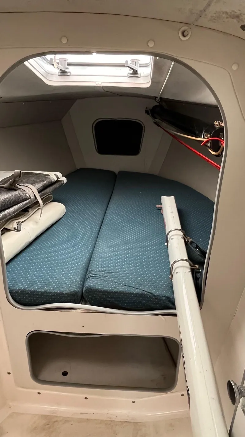 Slide: The Image of Interior cabin of 2001 J Boats J/105 sailboat with blue cushions and storage space. - 14