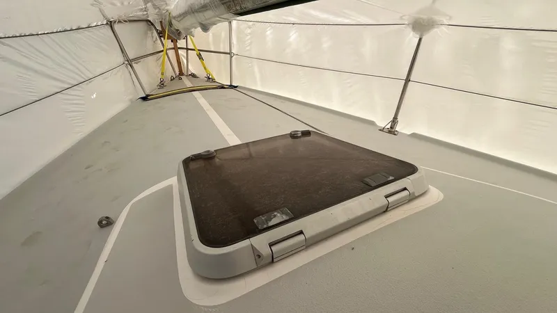 Slide: The Image of 2001 J Boats J/105 deck under protective cover, featuring a hatch. - 7