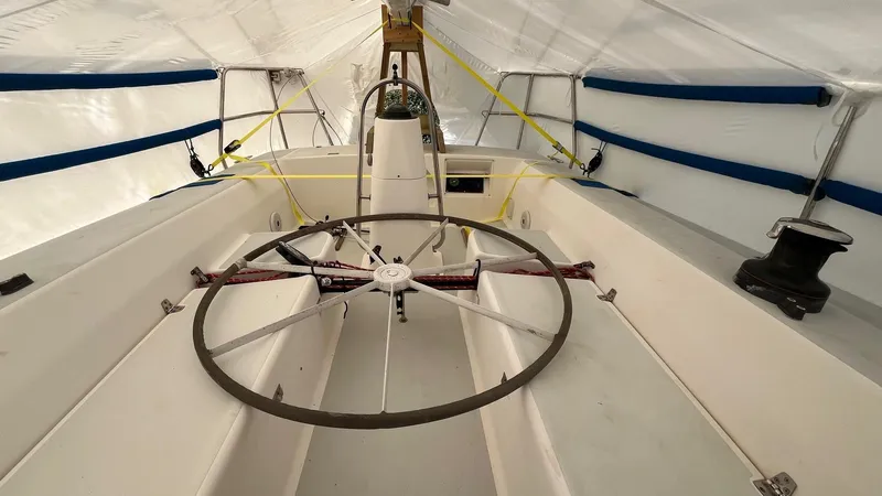 Slide: The Image of 2001 J Boats J/105 sailboat cockpit with large steering wheel under cover. - 9