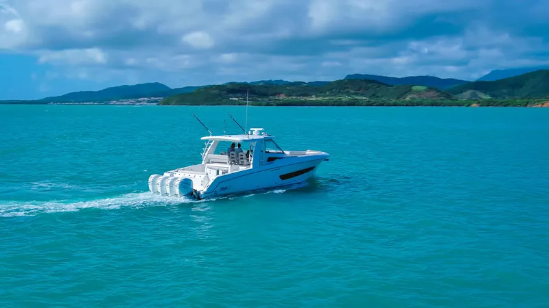 Slide: The Image of 2017 Boston Whaler 420 Outrage cruising on turquoise waters under a blue sky. - 10