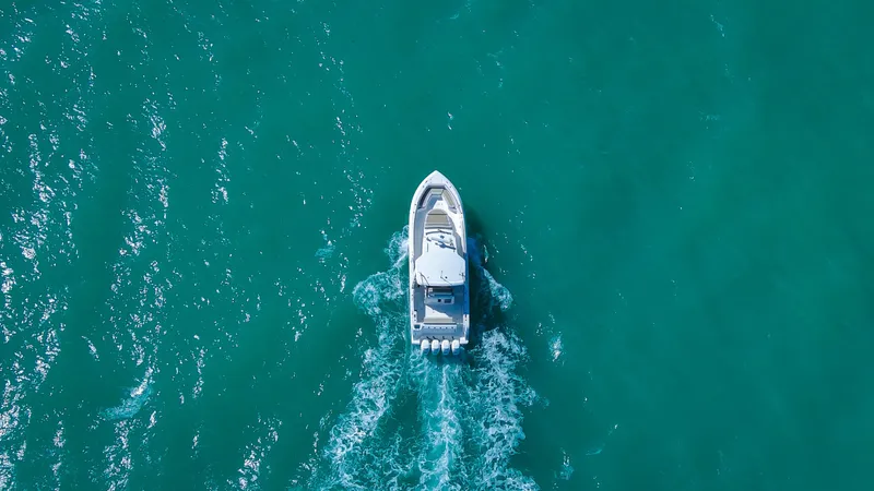 Slide: The Image of Aerial view of 2017 Boston Whaler 420 Outrage cruising on turquoise water. - 11