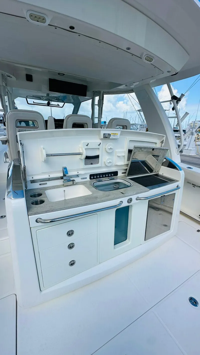 Slide: The Image of 2017 Boston Whaler 420 Outrage boat kitchen area with modern amenities and sleek design. - 13