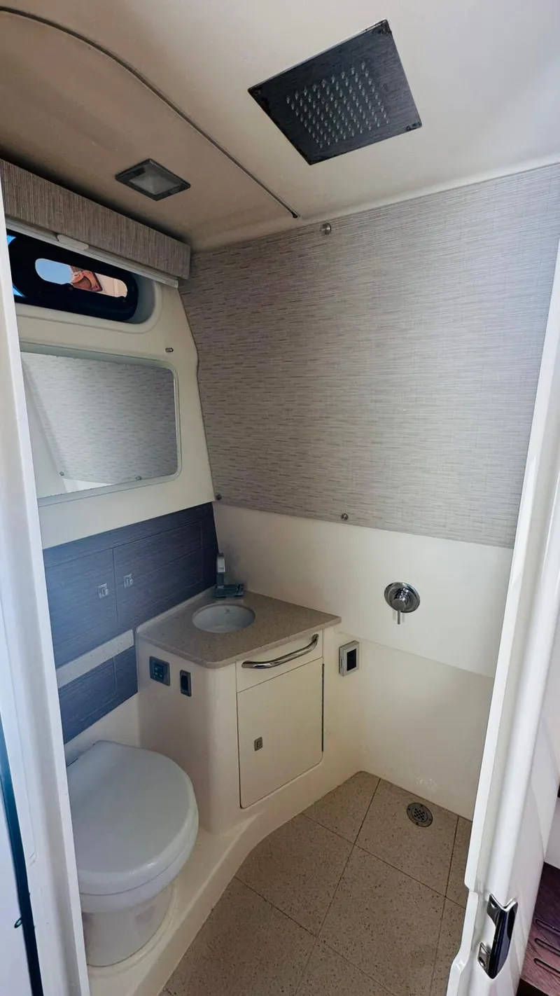 Slide: The Image of 2017 Boston Whaler 420 Outrage bathroom with modern fixtures and compact design. - 15