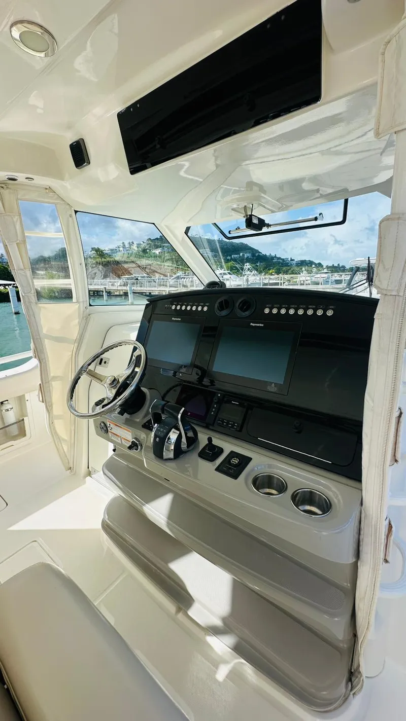 Slide: The Image of 2017 Boston Whaler 420 Outrage helm with modern controls and navigation systems. - 19