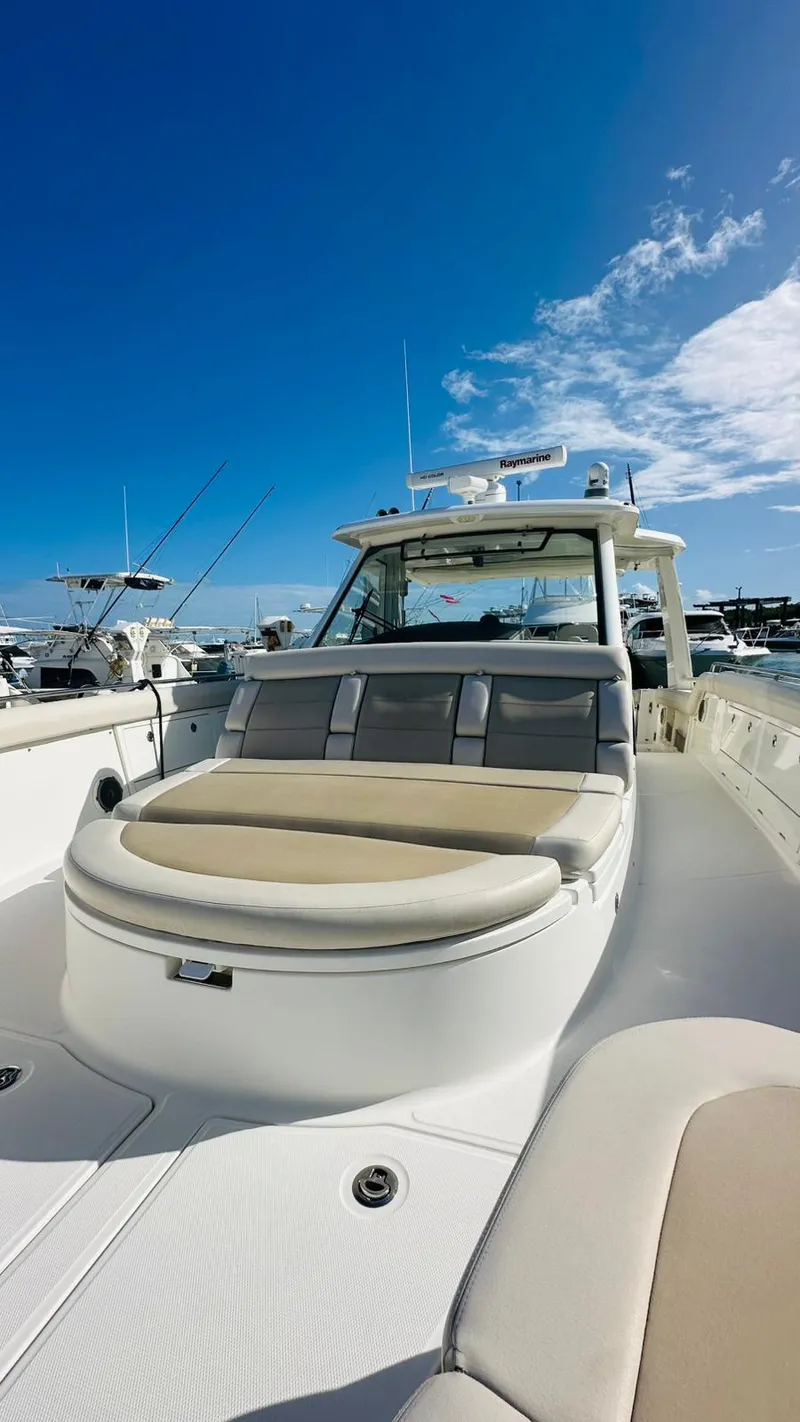 Slide: The Image of 2017 Boston Whaler 420 Outrage boat with spacious deck under clear blue sky. - 20