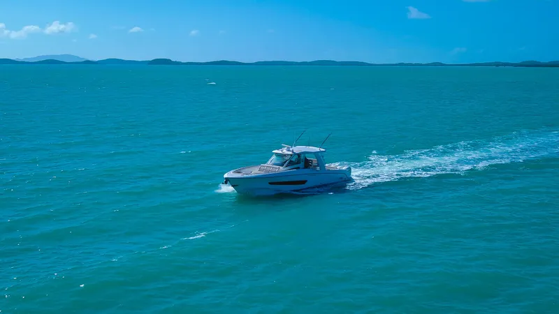 Slide: The Image of 2017 Boston Whaler 420 Outrage cruising on open blue sea under clear sky. - 3