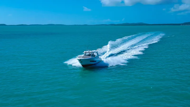 Slide: The Image of Boston Whaler 420 Outrage 2017 cruising on turquoise ocean under clear blue sky. - 4