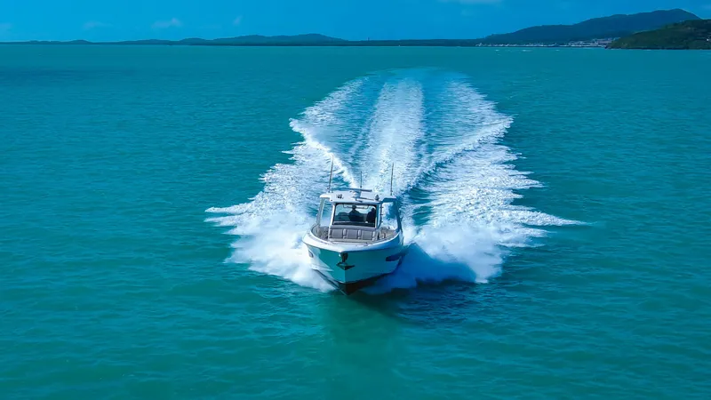 Slide: The Image of 2017 Boston Whaler 420 Outrage cruising on turquoise waters, leaving a wake behind. - 5
