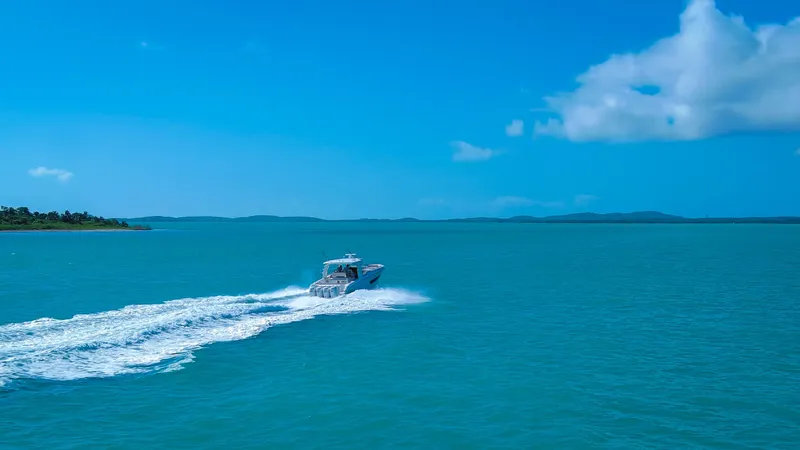 Slide: The Image of 2017 Boston Whaler 420 Outrage cruising on open blue sea under clear sky. - 6