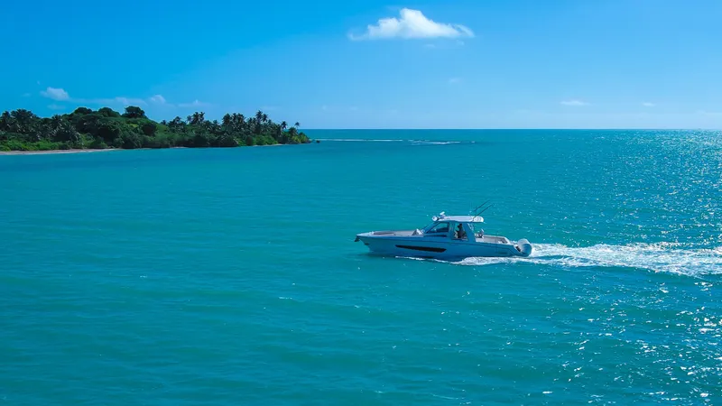 Slide: The Image of Boston Whaler 420 Outrage 2017 cruising on turquoise ocean near tropical island. - 9