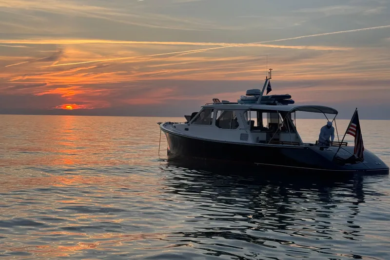Slide: The Image of True North 38 Heritage boat at sunset on calm waters, 2005 model. - 0