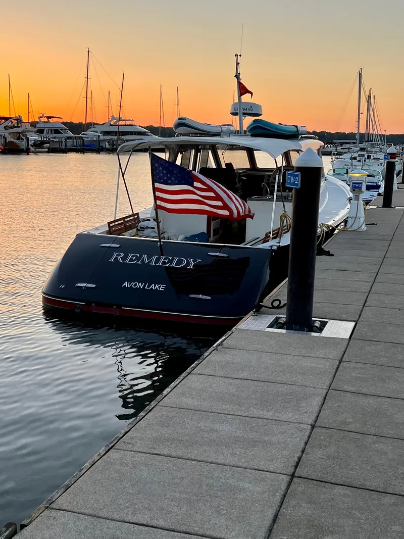 Slide: The Image of 2005 True North 38 Heritage boat docked at sunset with American flag. - 10