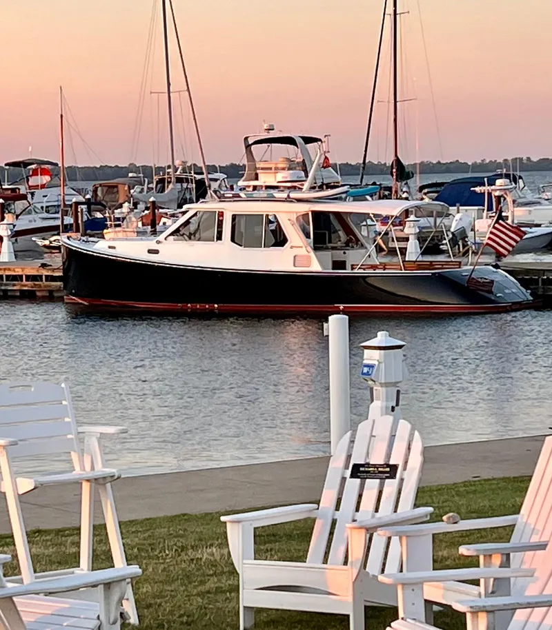 Slide: The Image of 2005 True North 38 Heritage yacht docked at sunset, surrounded by other boats. - 11
