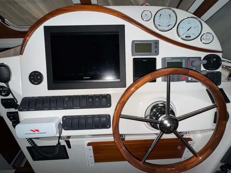 Slide: The Image of Helm of 2005 True North 38 Heritage boat with wooden steering wheel and navigation instruments. - 13