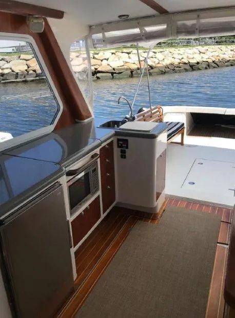 Slide: The Image of 2005 True North 38 Heritage yacht interior with kitchenette and waterfront view. - 14