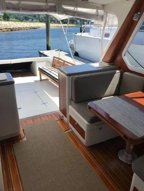 Slide: The Image of 2005 True North 38 Heritage yacht interior with seating, table, and waterfront view. - 15
