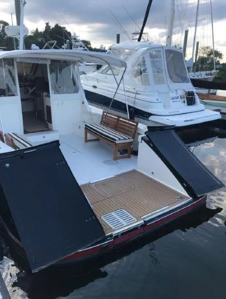 Slide: The Image of 2005 True North 38 Heritage boat docked with open rear deck and seating. - 17