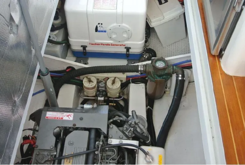 Slide: The Image of Engine compartment of 2005 True North 38 Heritage boat with generator and hoses. - 23