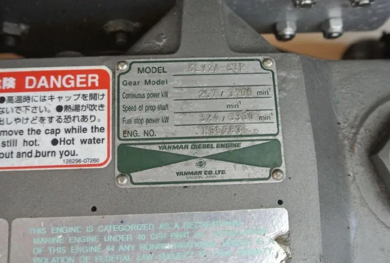 Slide: The Image of Yanmar diesel engine label with specifications and safety warning in multiple languages. - 24