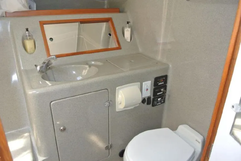 Slide: The Image of Compact bathroom in 2005 True North 38 Heritage boat with sink, toilet, and mirror. - 26