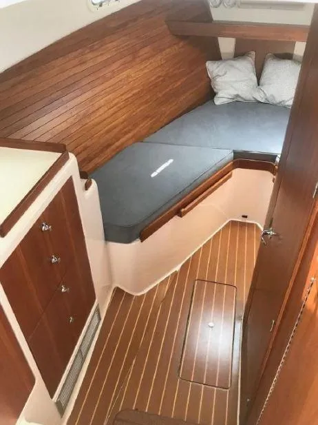 Slide: The Image of Cozy cabin interior of 2005 True North 38 Heritage boat with wooden finish and bedding. - 27