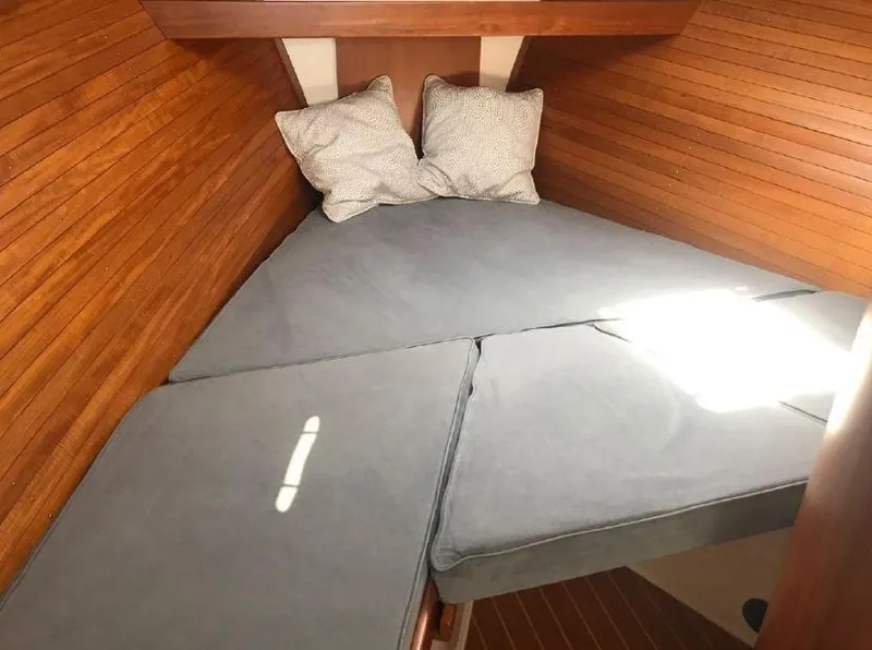 Slide: The Image of Cozy cabin interior of 2005 True North 38 Heritage with wooden walls and cushions. - 29