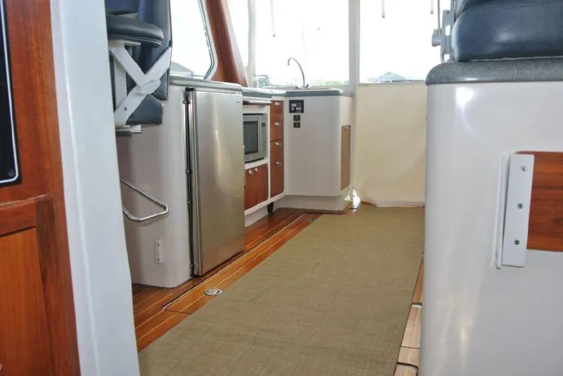 Slide: The Image of Interior of 2005 True North 38 Heritage yacht with kitchen and seating area. - 30
