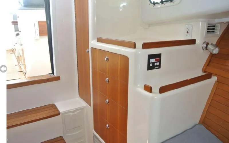 Slide: The Image of Interior of 2005 True North 38 Heritage boat with wooden cabinetry and seating. - 31