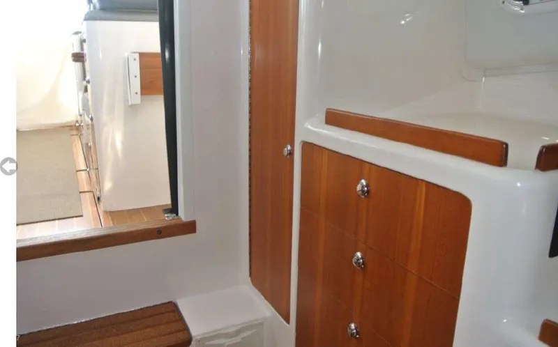 Slide: The Image of Interior of 2005 True North 38 Heritage boat with wooden cabinetry and seating. - 32