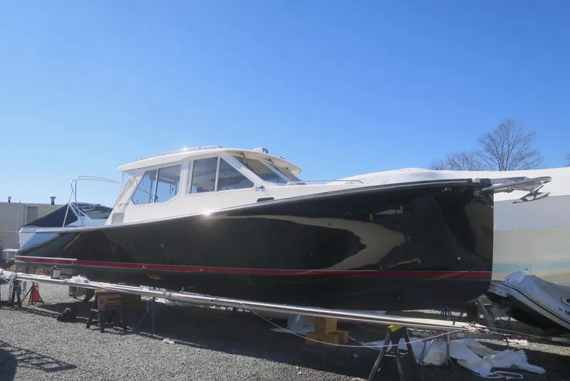 Slide: The Image of 2005 True North 38 Heritage boat on display under clear blue sky. - 4